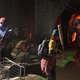 Four people stand in a sewer while a really big zombie runs at them in Back 4 Blood.
